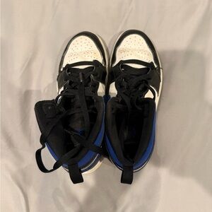 Nike Kids Black and White Sneakers with Blue Accents. Air Jordan 1 mid
